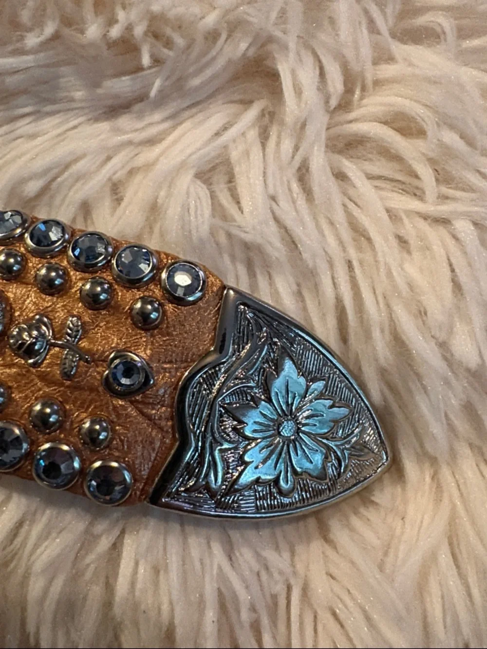 Kippy’s  bronze  metallic leather belt with light blue Swarovski crystals.